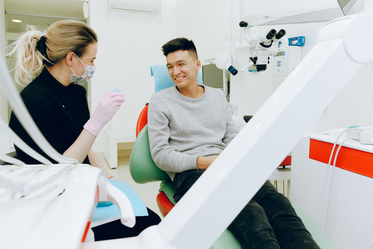 A patient smiling during a visit with their dentist